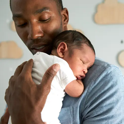 photo of father holding infant son